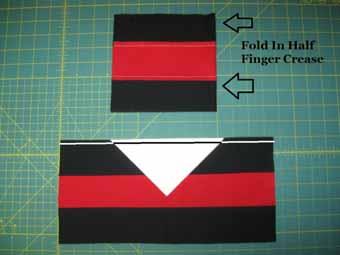 Align a White Triangle with right sides together on the strip set matching the finger crease with the point of the triangle. Stitch a 1/4" seam along the side of the strip set.