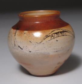 Raku fired and reduced post firing for dynamic lustre and swirling