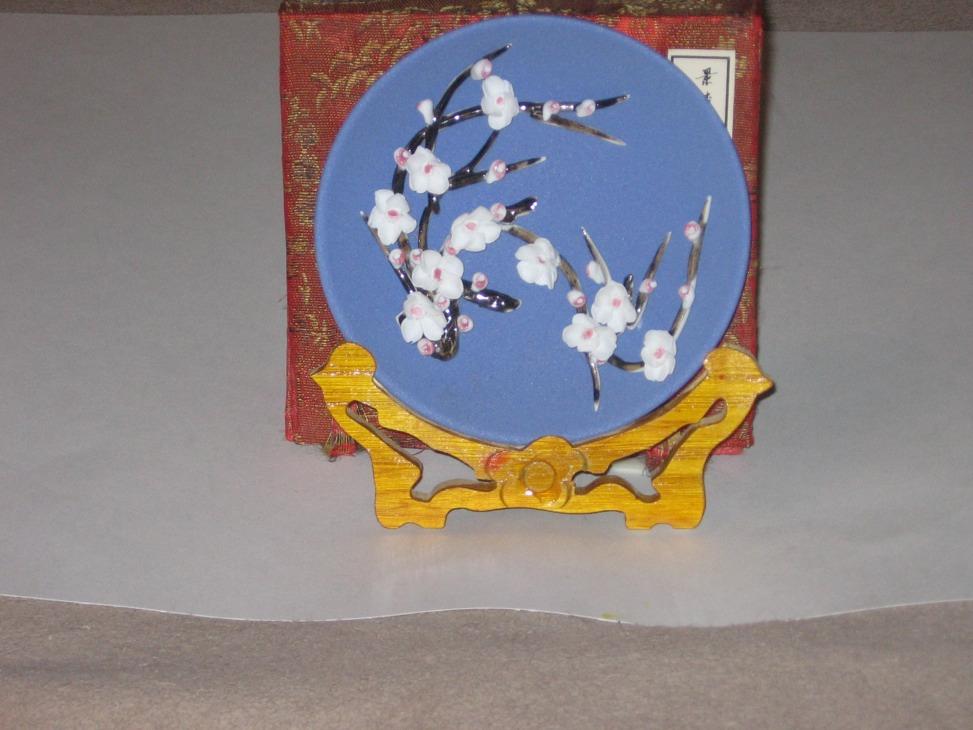 This plate is a smooth plate with pop-out flowers on them, this plate is from China. This plate was hand made and the plate came in a red silk box.