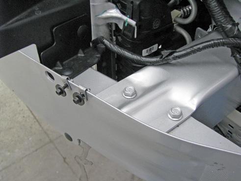 Using a 13MM socket, remove the four bolts (white arrows) from