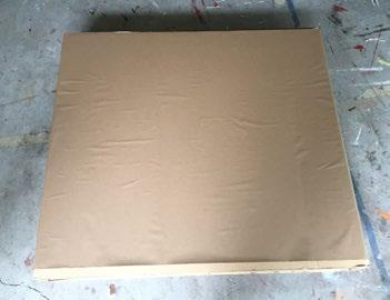 Cover the smaller box in spray adhesive and wrap in brown paper to