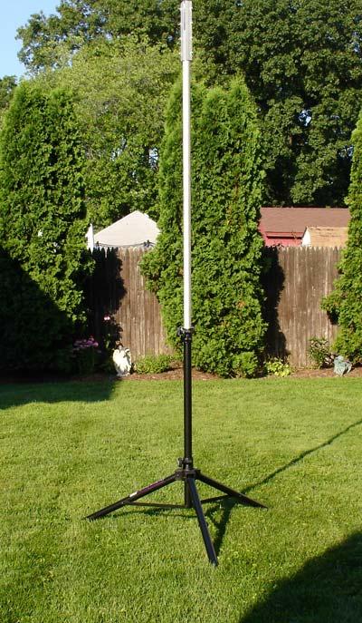 Place a 6 feet piece of wood against the tripod legs so that it will not slip when the mast is