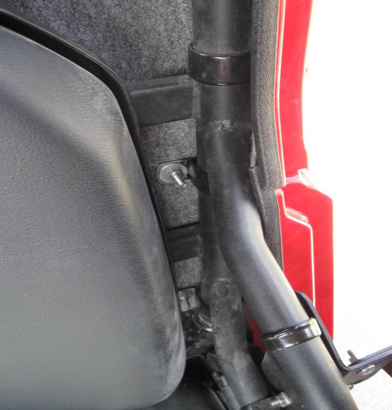 Be sure to position the upper vinyl clamp on each side of the roll cage. Both driver and passenger side clamps are located as shown here. Figure 1 2. Install the lower side panel.
