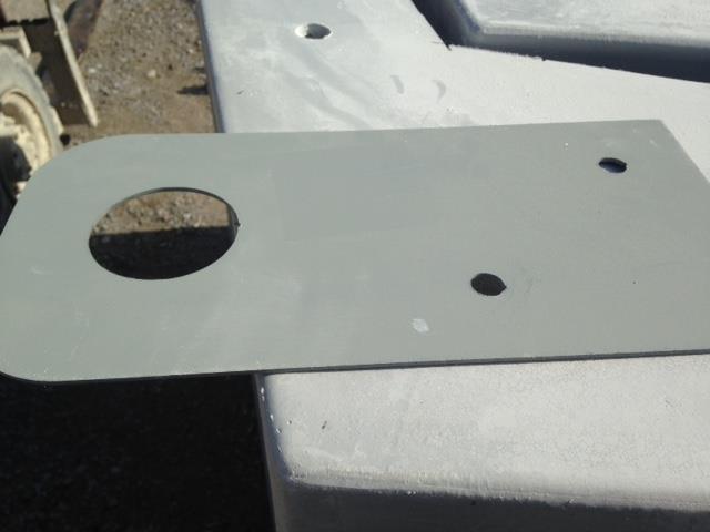 Drill a hole through the fiberglass panels using the lower hole on the lifting eye as your guide.