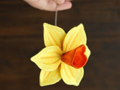 Then use a hand sewing needle and matching thread to sew the petals onto the center piece.