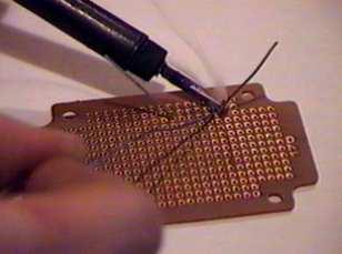 Lay the iron tip so that it rests against both the resistor lead and the board. It may take one or two seconds to heat the component up enough to solder. 4.