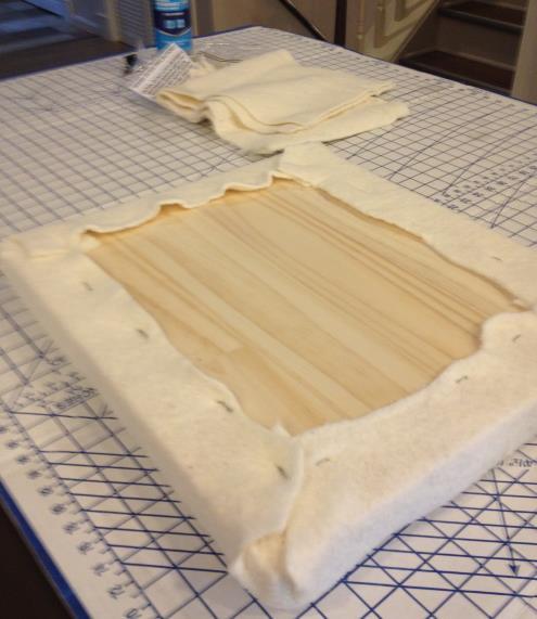 Step 10a: Seat cushion batting: Apply 1 foam to top of seat board with spray adhesive.