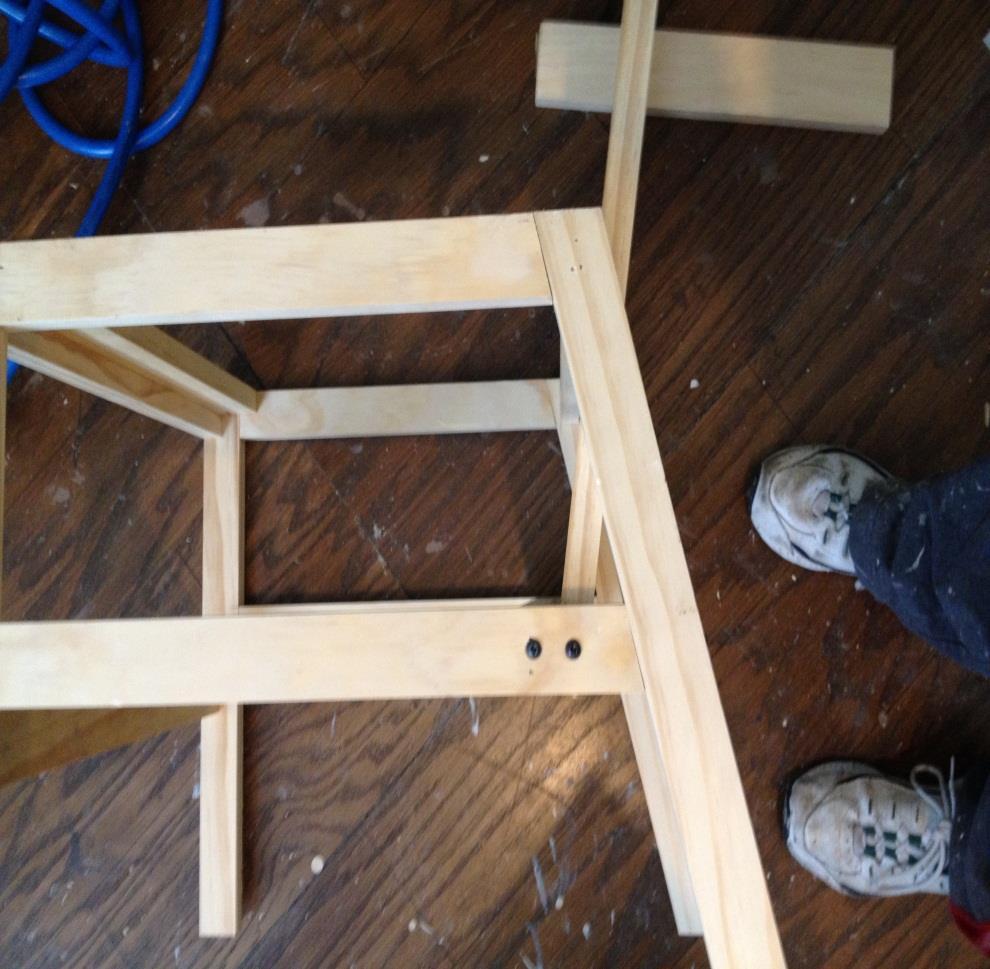 Step 6: Attach chair back, bottom screws Front edge of chair back lines up with point here. 1x scrap for prop Bottom edge of chair back (back edge) lines up with bottom of lower support.