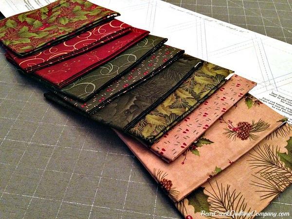 Cutting fabric triangles: Select 18 fat quarters from the bundle, and press them. I chose the rich, dark shades for my quilt. It's easy to stack 3 fat quarters at a time for cutting.