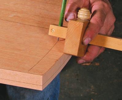 Use a pencil to lay out the limits of the top s underturned edge profile, marking one line on the edge and another on the underside (top).