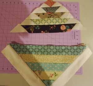 Sew the top half of the basket quilt block as shown. You will notice that once the strips are attached to the triangles, they are slightly more wide.