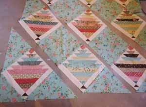 When cut using these directions, it is ensured that the bias edges of the setting squares face in. This keeps the patchwork from stretching when adding the checkerboard borders.