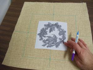 Create a paper template of the design by printing the design at full size using embroidery software. Poke a hole in the center of the template and align it with the center point on the fabric.