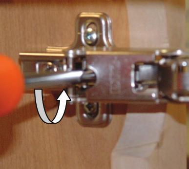 Turn screws counter-clockwise to move the door towards the center of the cabinet.