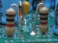 Figure 32. Resistors are mounted vertically, body on the circle As the parts are installed, it is recommended to both check the box below and cross off the part on the picture above.
