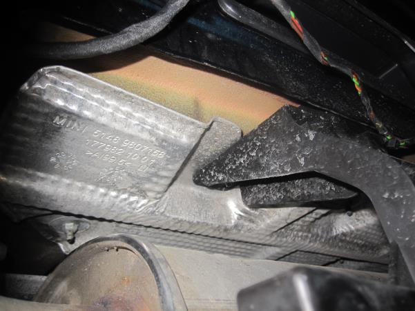 Using the 10mm socket with a long extension, remove the 4 nuts in the D location. This is under the car and above the muffler as shown in Picture 5.