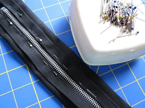 Stitch the zipper in place along each side