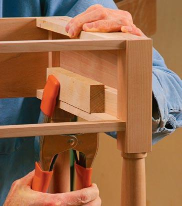 clamped in place, flush with the top and bottom of the aprons and rails. Trim the spacers perfectly flush with the inside faces of the legs.