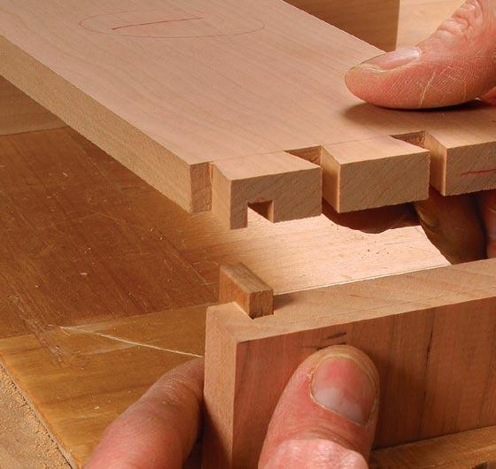 Secure the pin board in a vise and use a spacer block to keep the tail board level on the pin board