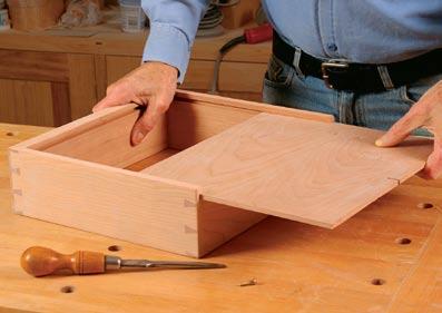 Becksvoort runs the groove for the drawer bottom on the tablesaw, and then uses the groove (and a