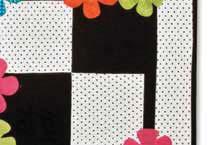 Position groupings of five large flowers on quilt using diagram for inspiration. Add small flowers and flower centers.