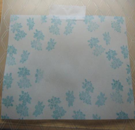 Step 16. Use a heat tool to gently dry the parchment as excessive heat with warp the parchment. Open the Couture Creations tied together embossing folder up.