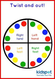 The adult calls out instruction: left leg on red circle, right hand on blue circle.