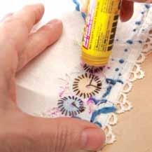 Place a piece of precut glass over the embroidered textile and cut down to size.