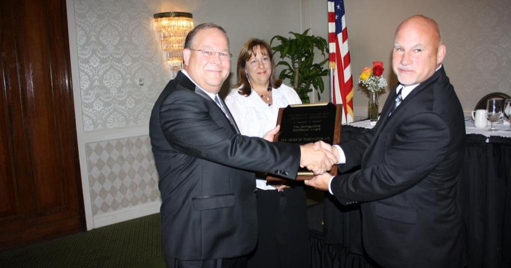 Tim Abner (left) received the Distinguished Distributor Award, presented to an individual who, by