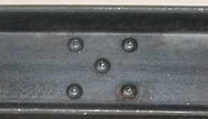 I had no intention of installing those braces but the the rivets on the I beam end were used to hold the two channels of each I beam together.