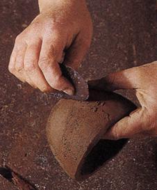 The constructed pot becomes Leatherhard as it begins to dry and it still feels damp and cool to the touch but if you tried to bend it, it would break.