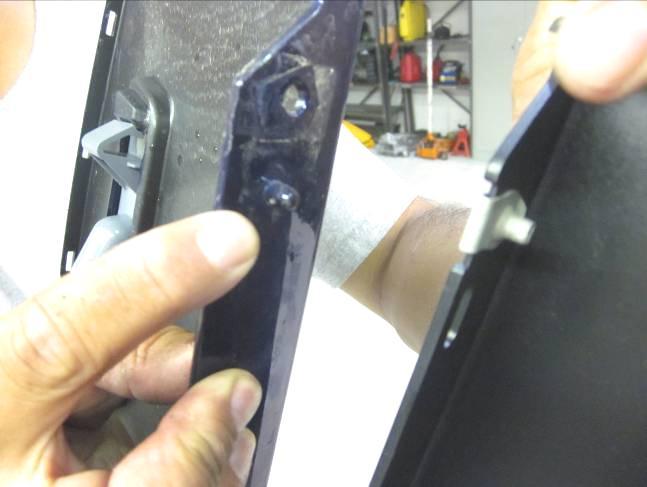 Align the two tabs next to taillight openings (dislodged in Step #11) and carefully press into place.