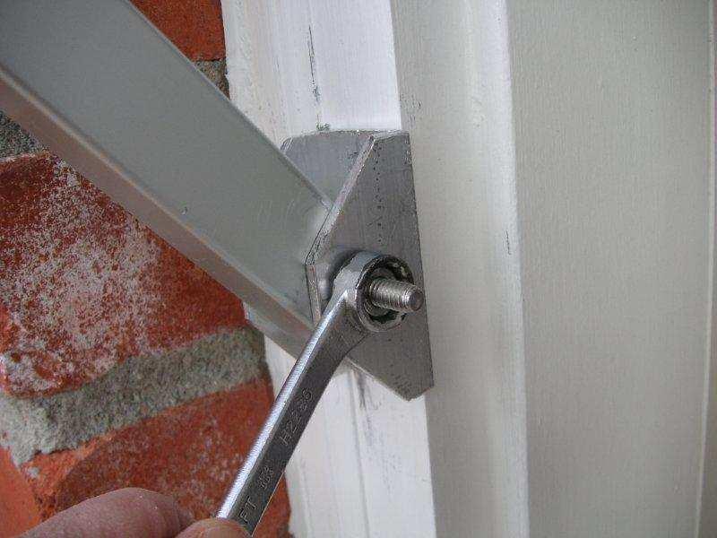 Secure the brackets to the wall using the marks made in the