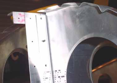 The top flange of the rib is flush with the top of the spar.