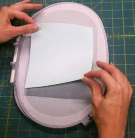 Hoop parchment paper up-side down and trim all excess from edges. See Photos 2 and 3 9.