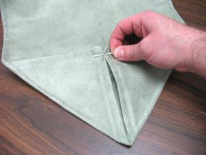 With needle and thread, tack the center back of the folds in place.