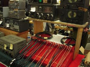 Three rows of tables stretch the length of the room on two floors, filled with old radio equipment, new radio