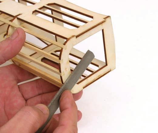 Use a file or sanding block to smooth the strips cut in