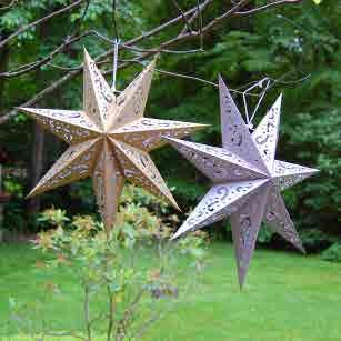 These 7 pointed star designs are made from cardboard and beautifully printed in gold or silver with punched swirl designs. The die cut swirls allow in natural light to enhance the overall design.