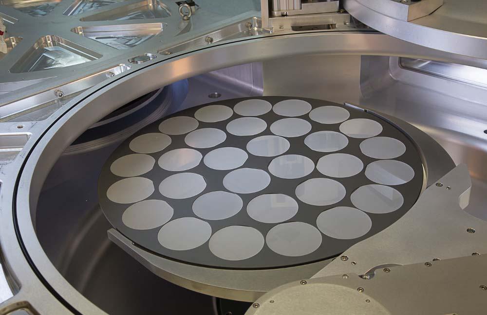 COVER STORY MOCVD The Veeco EPIK 700 system s automated robot loads 31-4 inch sapphire wafers into the MOCVD reactor.