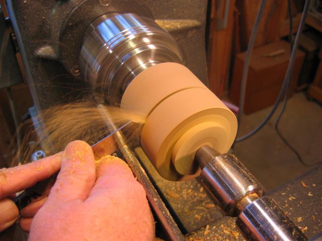 Measure the length of the blank between the spigots to layout for the parting cut to separate the lid and