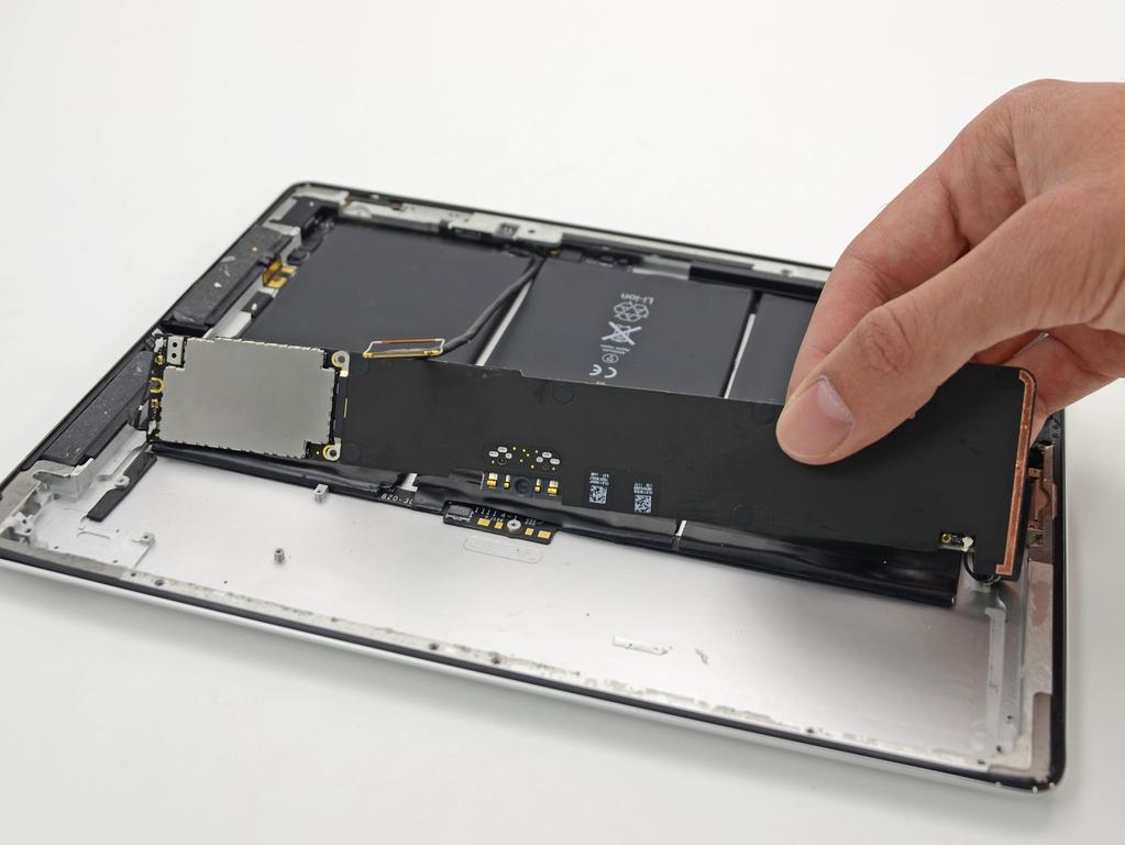The logic board is adhered to the rear case; work slowly and uniformly to peel up the glue without damaging the board.