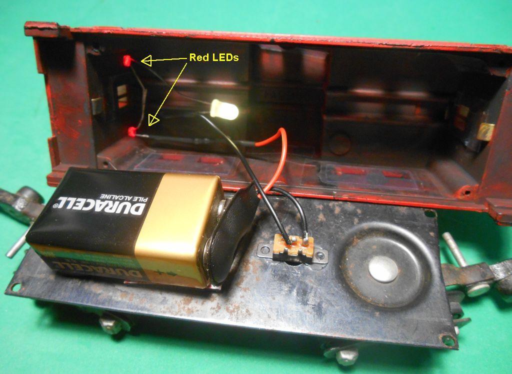 Step 6. Reassemble the Caboose. Push the red LEDs into the socket holes in the rear wall.