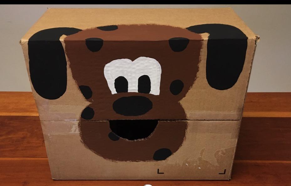 Feed the Dog Cardboard box Packaging tape Paint Pencil Scissors Bean bags Tape the box closed with packaging tape Draw a large dog face on the box Cut out the mouth