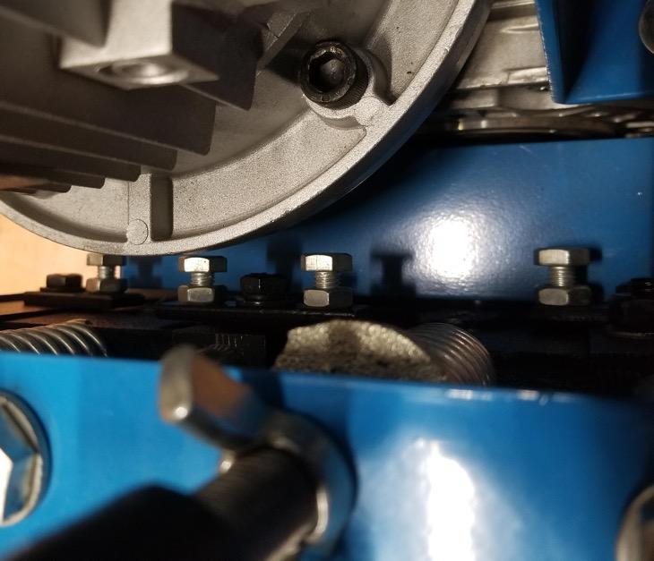 bolts on each side of the machine as shown.