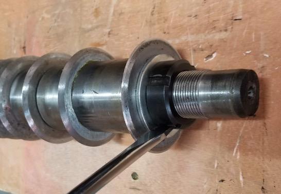 16. Place a flat punch against the spanner nut as shown. 17. Very carefully hold the blade assembly and tap the punch with a hammer until the nut is loose.