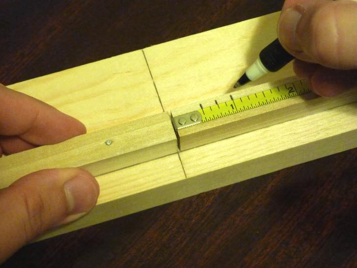 Next, use your ruler (or tape measure) to mark measurements down along each dowel fence