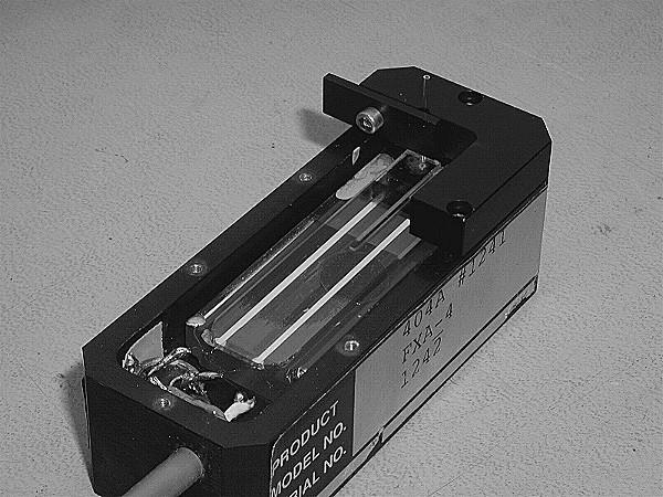 INSTRUCTION MANUAL PAGE 8 OF 12 Photograph 4 Tube Alignment Jig Attached to Transducer Head and with a Tube in the Clamp 5.