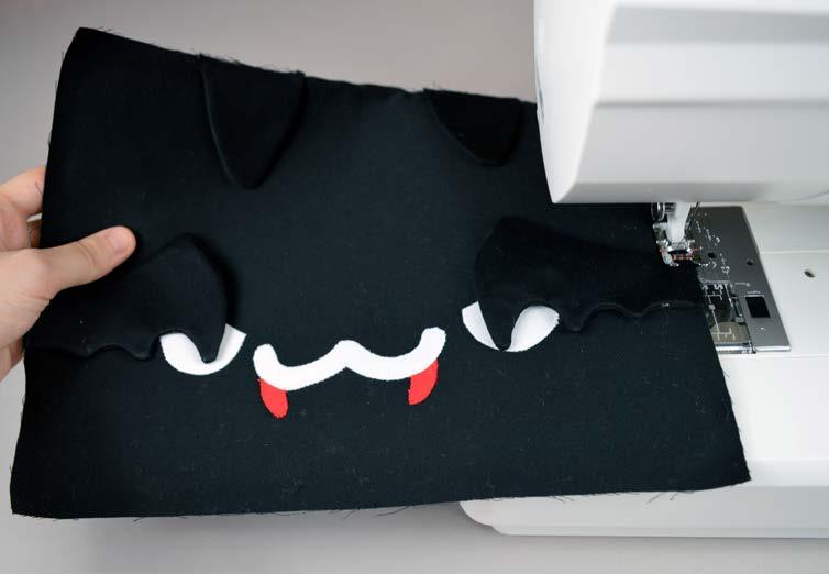 I used a zigzag stitch personally, but you could also use a straight stitch or satin stitch. Or, if you use heavyweight fusible web, you can skip the sewing altogether.