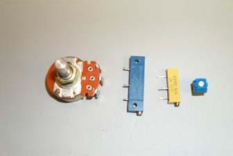 Resistors (Figure 3) are the small, usually light brown tubular things with wires (leads) sticking out of each end and four colored rings on the body.